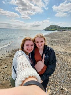 Two students take a selfie at the coast in Ireland.