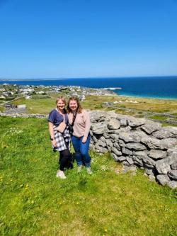 Two TR students pose at a cliff in Ireland