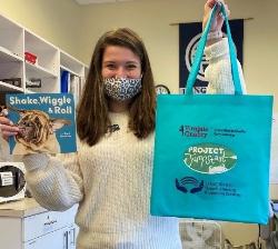 Hannah Millirons (Kraemer Family Foundation Graduate Assistant for the 2020-2021 academic school year ) holding a Book Buddy Example.