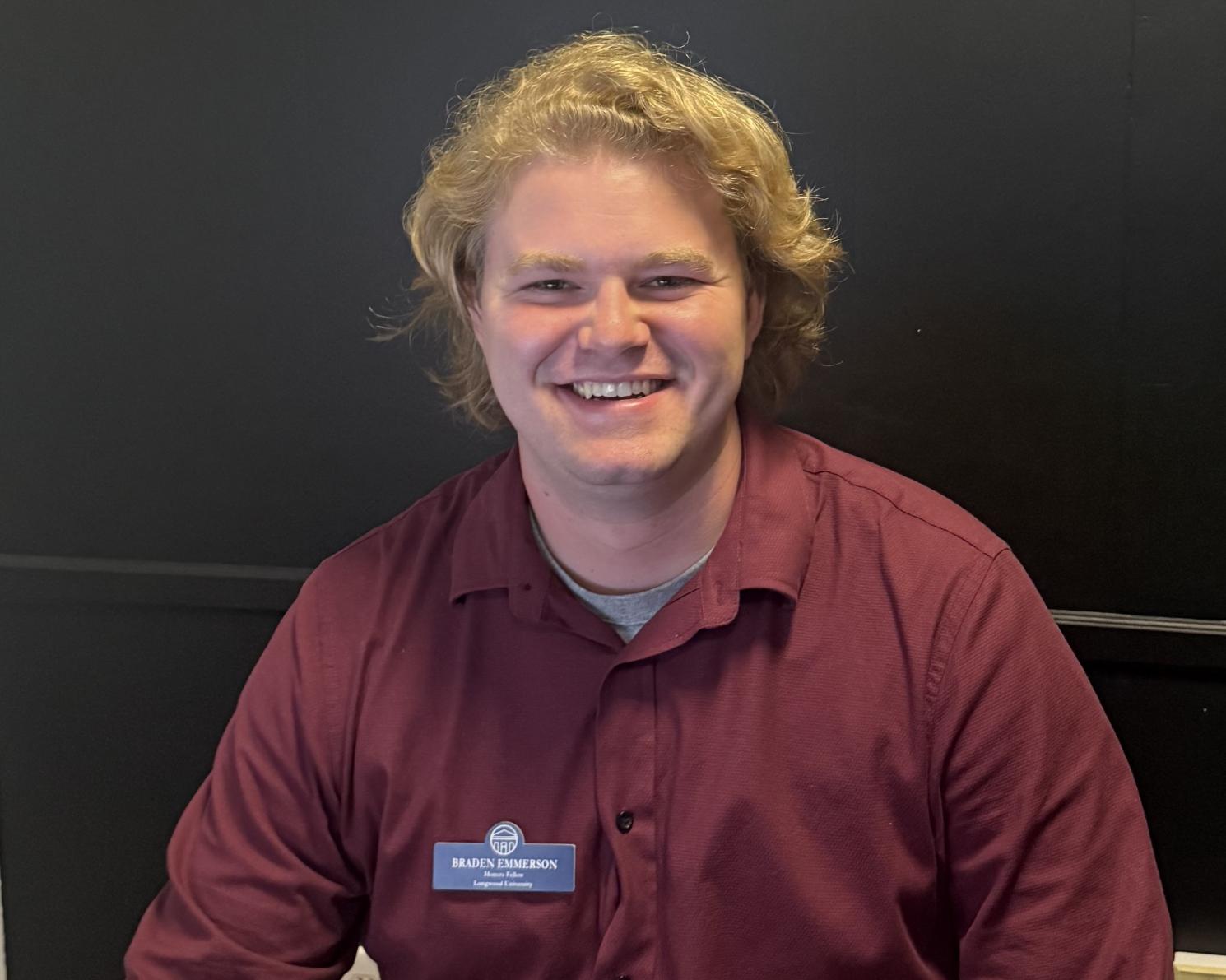 Braden smiling with a Longwood University name tag on his shirt.